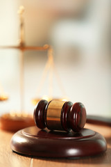 Wooden judges gavel on wooden table, close up