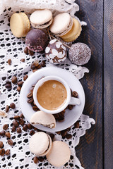 Gentle colorful macaroons and  coffee in mug