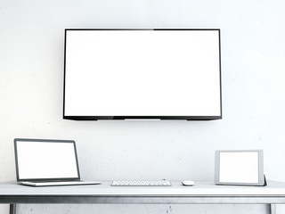 Table with laptop and large screen on the wall