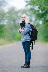 Young cute blonde with backpack outdoors