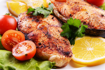 Tasty baked fish on plate close-up