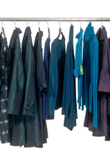 female different autumn clothing hanging on hangers