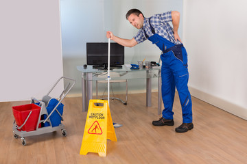 Male Worker Suffering From Back Pain