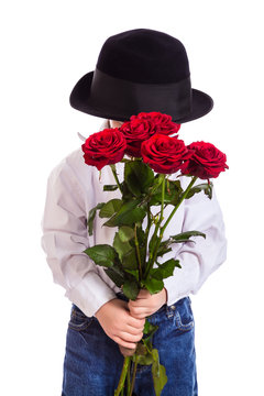 Shy little boy with red roses