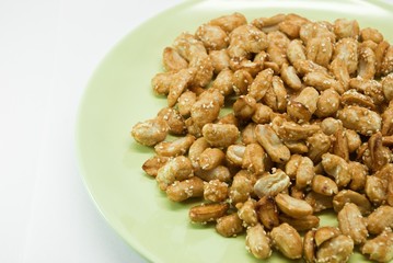 crispy peanut with sesame in green plate on white background
