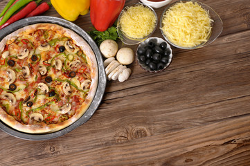Freshly baked Pizza making cooking with ingredients and copyspace photo