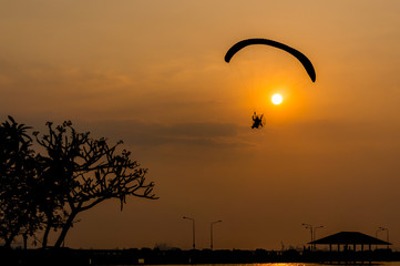 silhouette of paramotor with sunset sky
