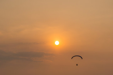 silhouette of paramotor with sunset sky
