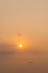 silhouette of paramotor with sunset sky
