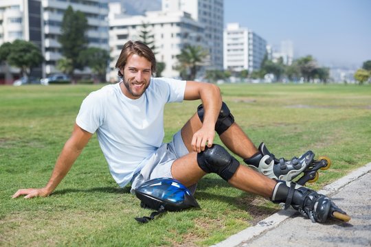Fit man getting ready to roller blade