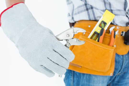 Technician using pliers over white background