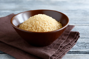 Brown sugar in the bowl on boards