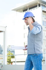 Architect using mobile phone outside building