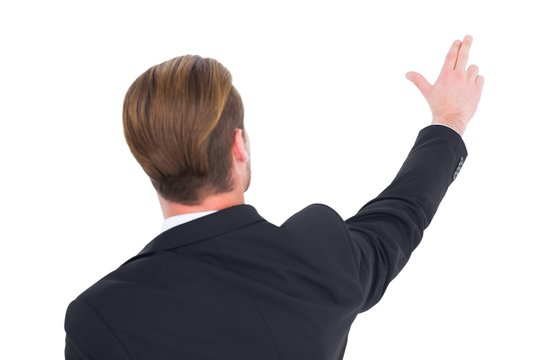 Rear view of businessman pointing with his fingers