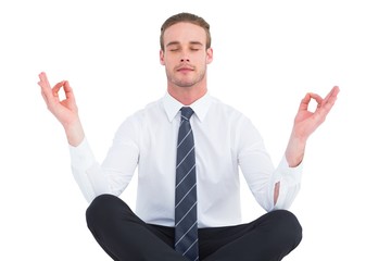 Businessman meditating in lotus pose