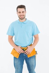 Portrait of happy carpenter wearing tool belt