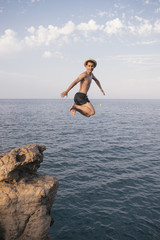 A man is dipping from a high cliff