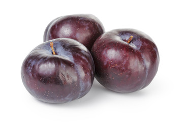 three ripe black plums isolated