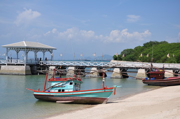 Fototapeta na wymiar Thai fishing wooden boat and Asdang Bridge as a background.
