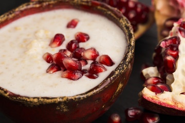 Dish of banana millet breakfast pudding with pomegranate