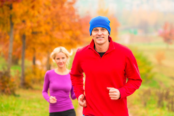 young married couple athletes on the morning jog