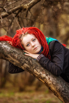 the girl with red dreadlocks in park