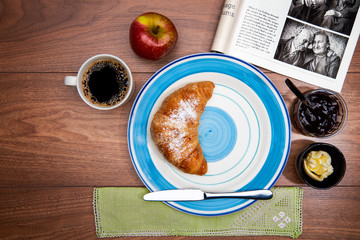 Continental breakfast with coffee, fresh croissants and magazine
