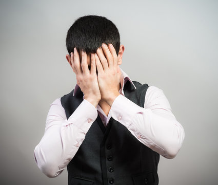 Frustrated businessman holding head in his hands