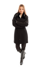 Fototapeta premium Young and beautiful female model wearing elegant black coat