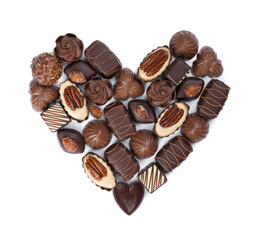 Heart shape made from various bonbons isolated on white