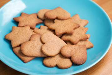 Star and heart shaped homemade cookies in a blue bowl