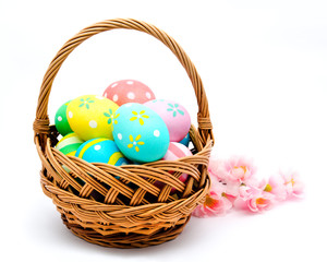 Colorful handmade easter eggs in the basket isolated