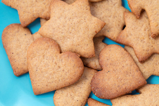 Star and heart shaped homemade cookies in a blue bowl