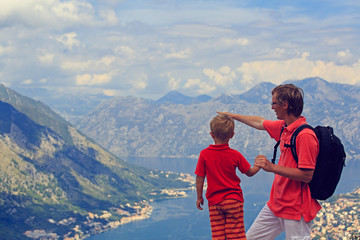 Fototapeta na wymiar father and son looking at mountains in summer