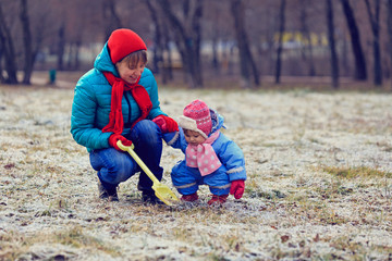 mother and little daughter playing in winter