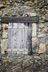 Old wooden shutters on stone wall background