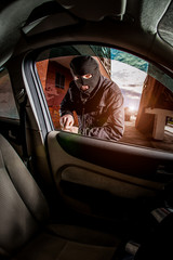 Car thief in a mask.