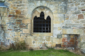 Fototapeta na wymiar Old stacked stone wall with window