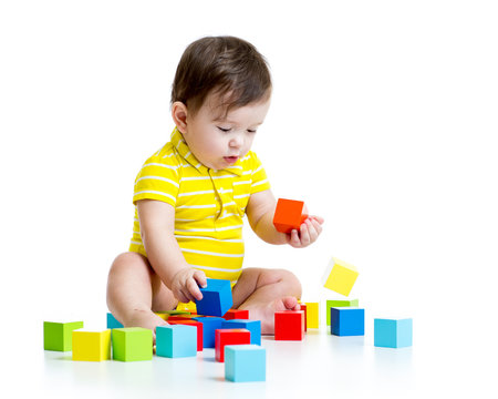 baby boy playing with wood toys