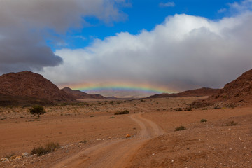 Fototapeta na wymiar Rainbow at the end of the road