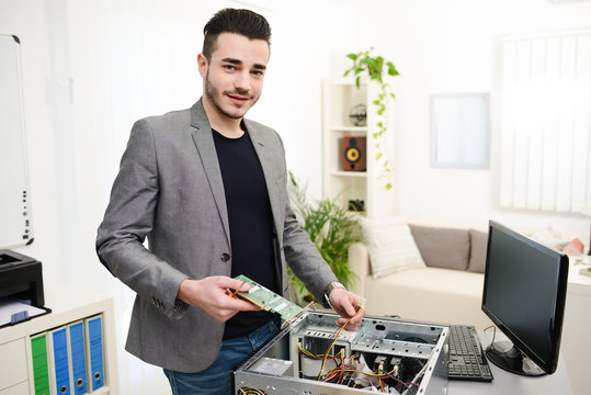 young man computer home repair fixing a computer