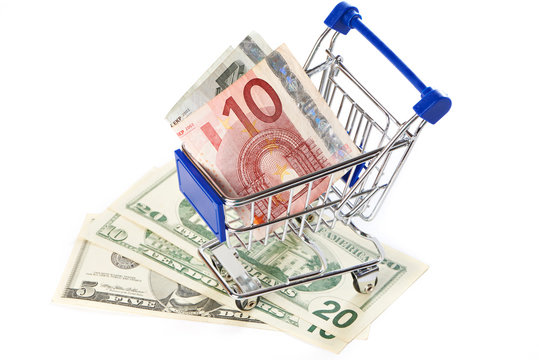 Shopping trolley with money isolated