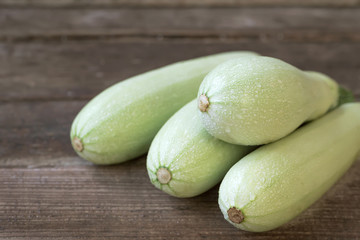 Fresh zucchinis on rustic table