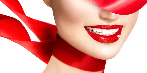 Beautiful model girl with red lips and blowing red silk scarf