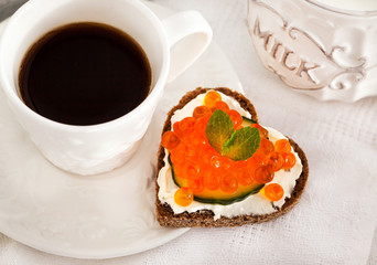 Romantic breakfast-toasts  with red caviar and coffee