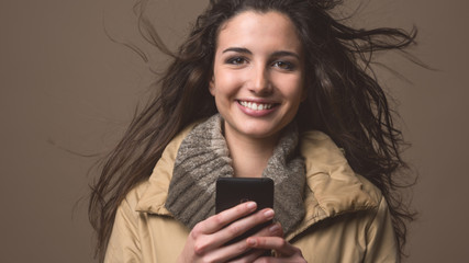 Smiling beautiful woman with mobile phone