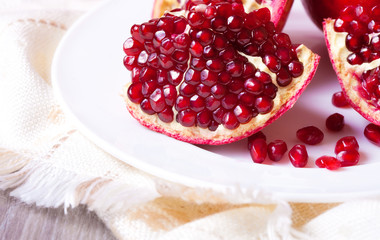 Closeup sliced pomegranate on white plate