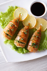 Grilled squid on a plate with sauce. vertical top view