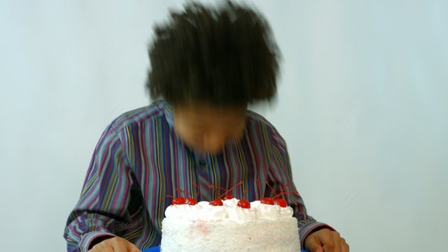 black birthday boy fell with his face in the cake