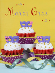 Mardi Gras cupcakes with purple mask toppers 